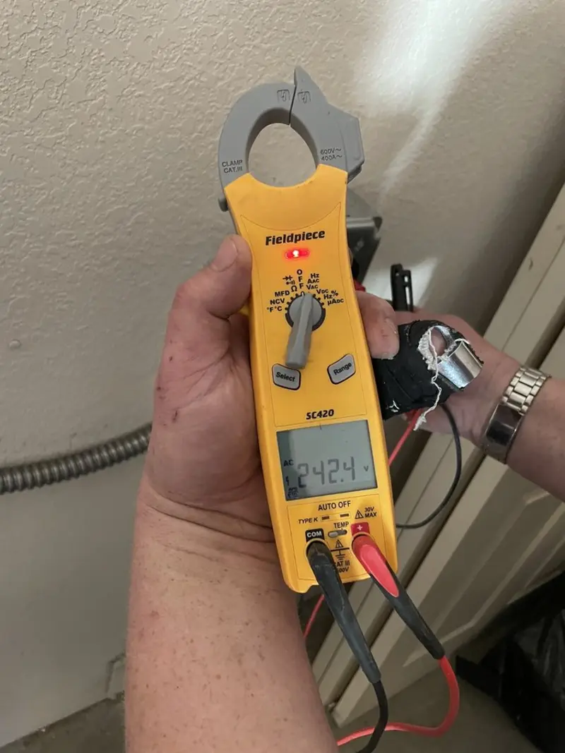 Voltage testing with clamp meter during Outlet Installation in Hialeah